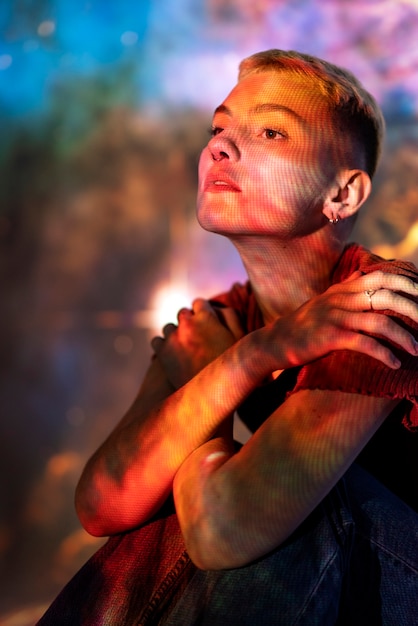 Portrait of young woman posing with universe projection texture