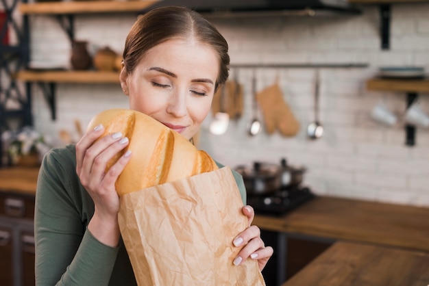 Portrait of young woman proud of fresh bread