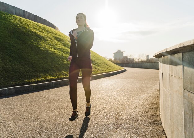 Portrait of young woman running