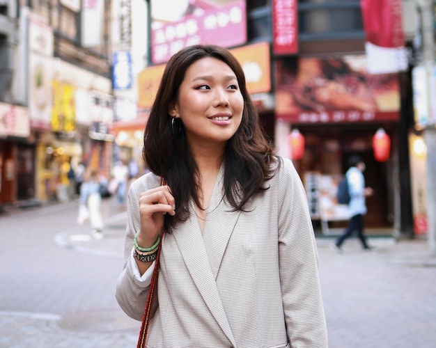 Portrait of young woman smiling on the street