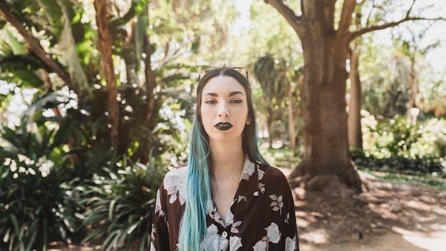 Portrait of young woman standing in the forest