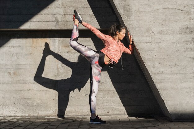 Portrait of young woman stretching