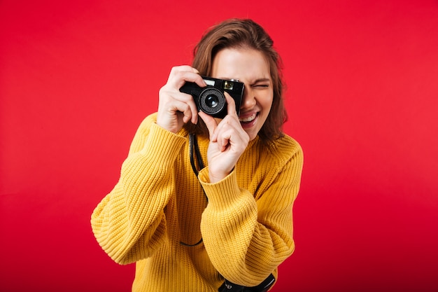 Portrait of a young woman taking a picture