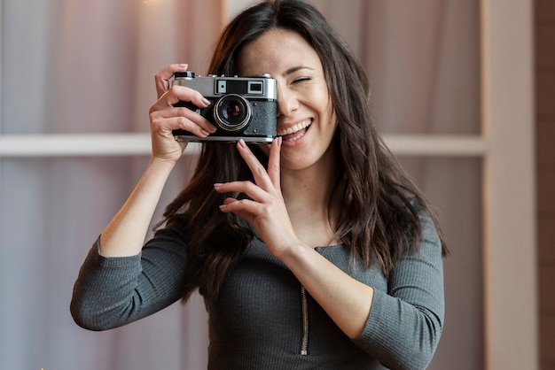 Portrait of young woman taking a picture