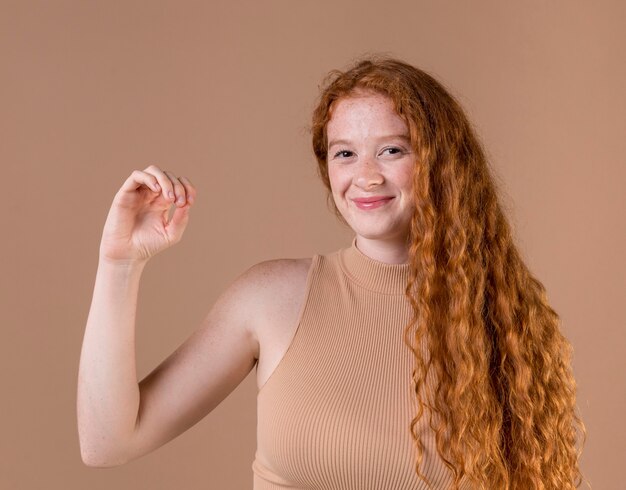 Portrait of a young woman teaching sign language