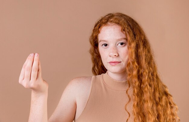 Portrait of a young woman teaching sign language