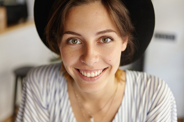 Portrait of young woman wearing big hat