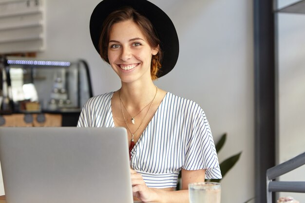 Portrait of young woman wearing big hat