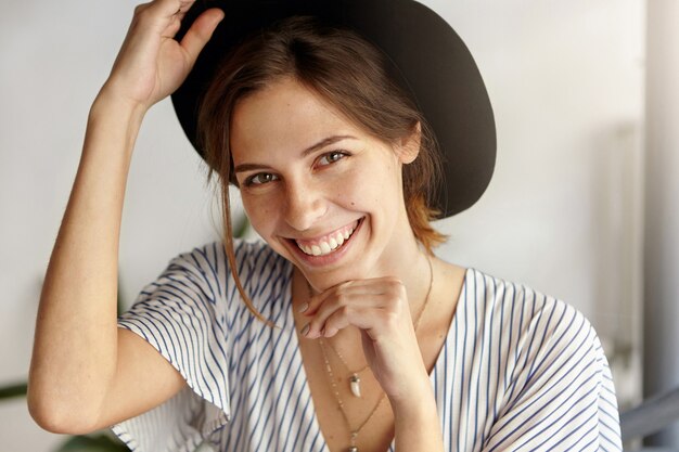 Portrait of young woman wearing big hat