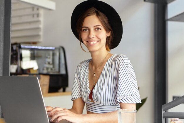 Portrait of young woman wearing big hat