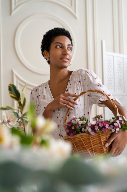 Free photo portrait of young woman wearing chic boho dress amongst flowers