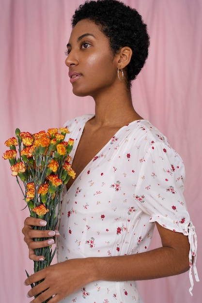 Portrait of young woman wearing chic boho dress amongst flowers