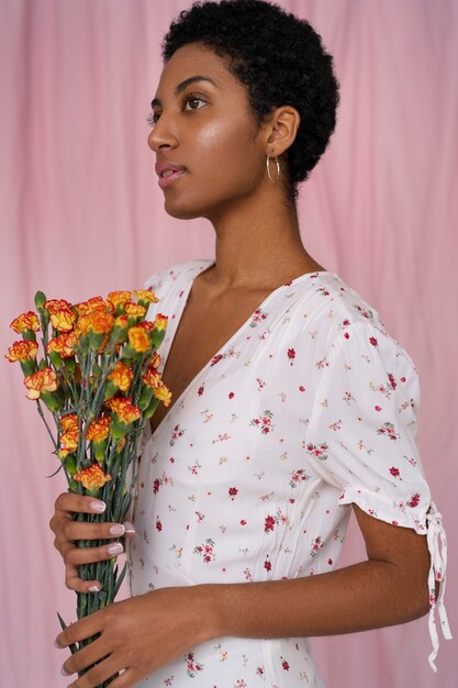 Portrait of young woman wearing chic boho dress amongst flowers