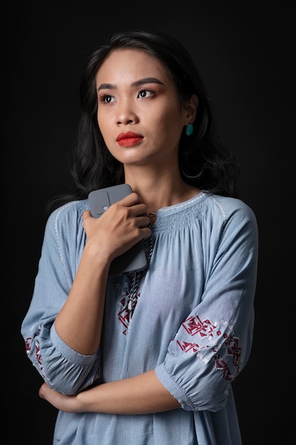 Portrait of young woman wearing embroidered shirt