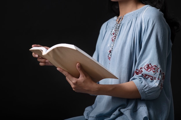 Portrait of young woman wearing embroidered shirt