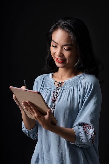 Portrait of young woman wearing embroidered shirt