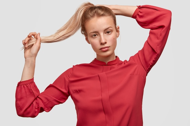 Portrait of young woman wearing red shirt