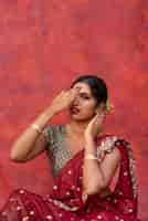 Free photo portrait of young woman wearing tradition sari garment