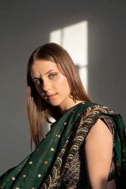 Free photo portrait of young woman wearing traditional sari garment