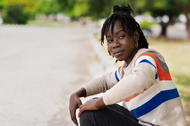 portrait of young woman with afro dreadlocks