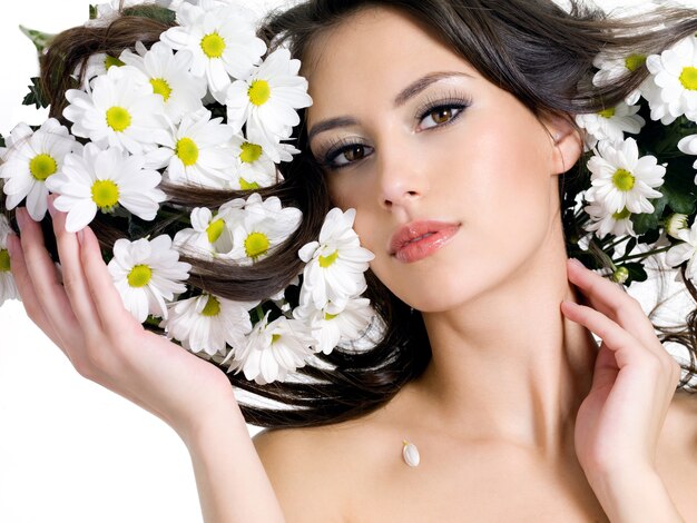 Portrait of young woman with flowers in her long hair - horizontal