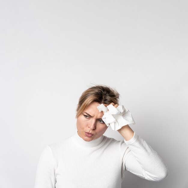 Portrait of young woman with headache