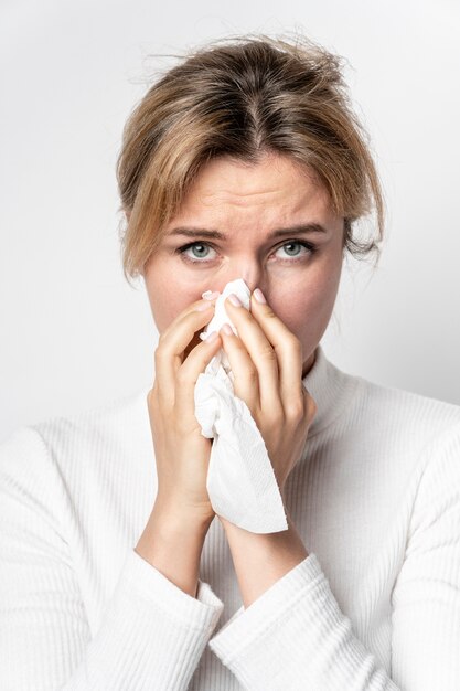 Portrait of young woman with illness symptom