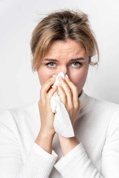 Portrait of young woman with illness symptom