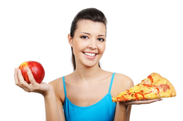 Portrait of young woman with pizza and red apple