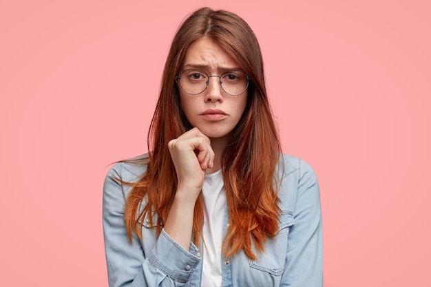 Portrait of young woman with round glasses