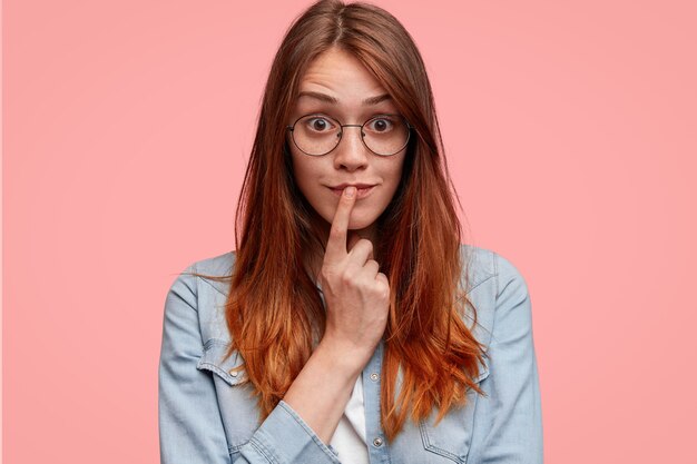 Portrait of young woman with round glasses