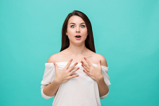 Portrait of young woman with shocked facial expression