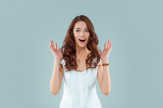 Portrait of young woman with shocked facial expression