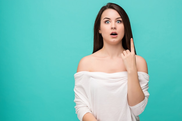 Portrait of young woman with shocked facial expression