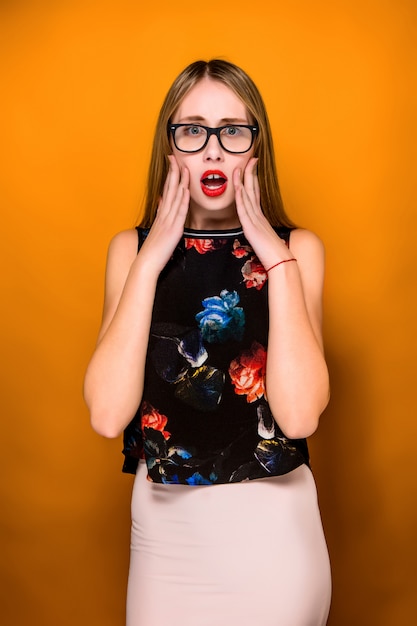 Portrait of young woman with shocked facial expression