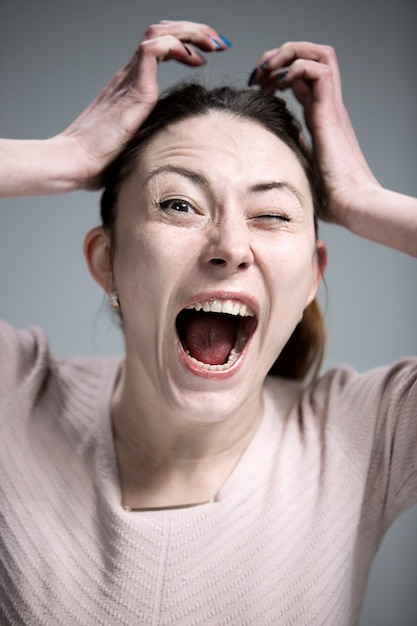 Portrait of young woman with shocked facial expression