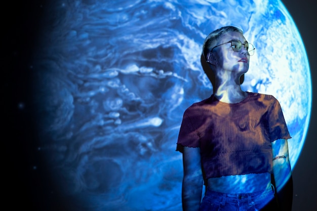 Portrait of young woman with universe projection texture