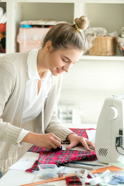 Portrait of a young woman working with a sewing pattern