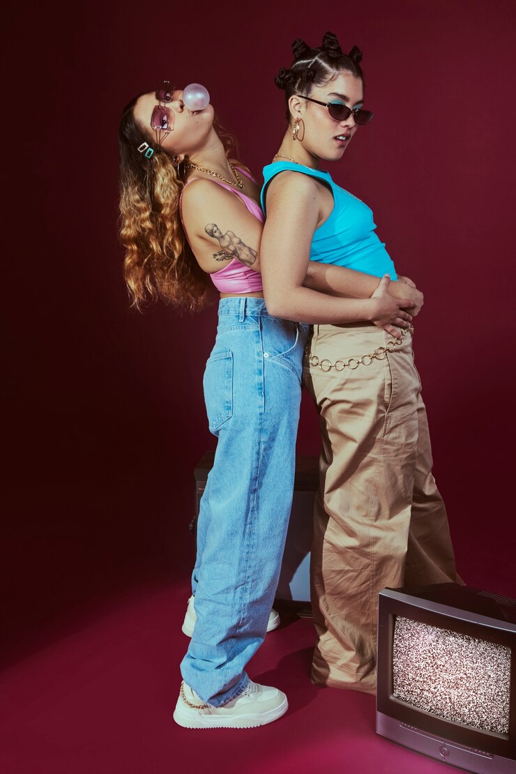 Free Photo portrait of young women in 2000s fashion style posing with bubblegum
