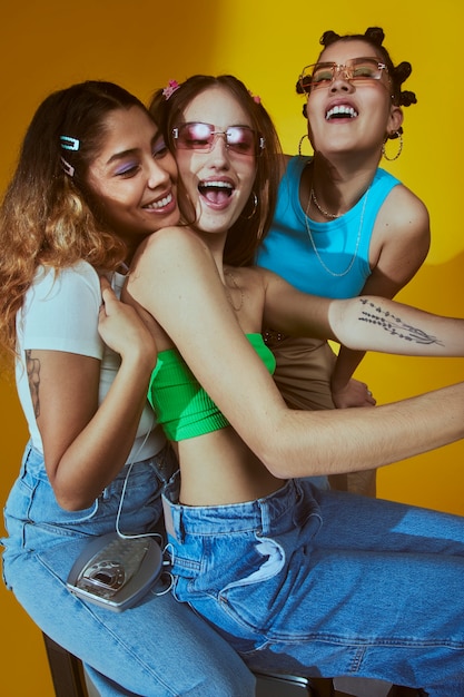 Free photo portrait of young women in 2000s fashion style posing with camera