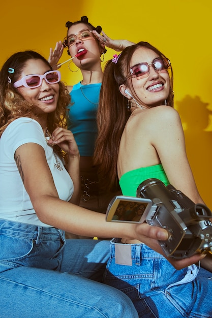 Portrait of young women in 2000s fashion style posing with camera