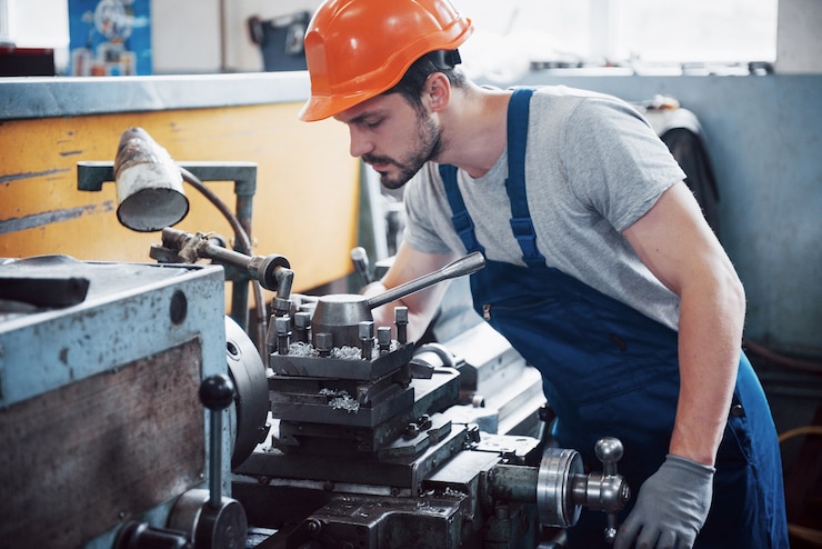 Free Photo portrait of a young worker in a hard hat at a large waste recycling factory.