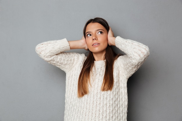 Free photo portrait of a young worried girl in sweater