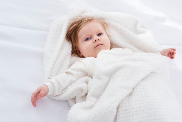Free photo posing baby in blanket