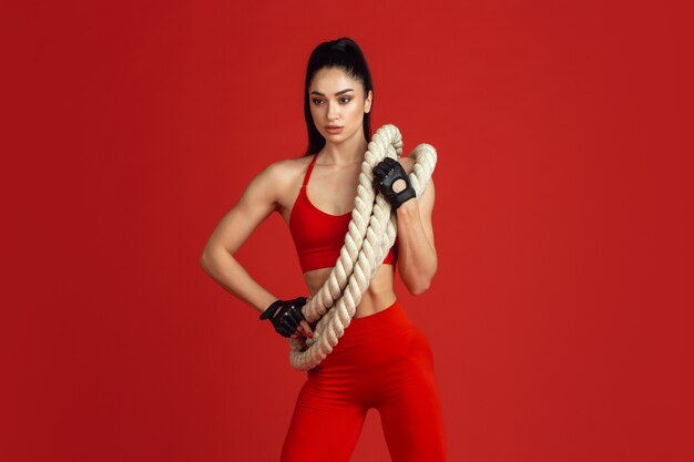 Posing strong. Beautiful young female athlete practicing in studio