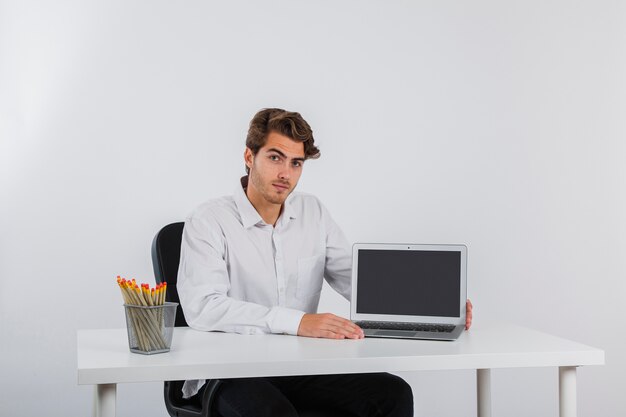 Posing with laptop in the office