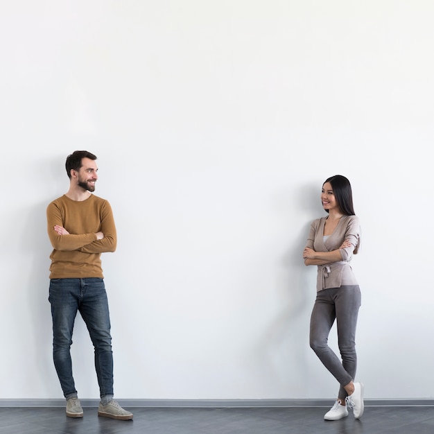 Positive adult male and woman looking at each other