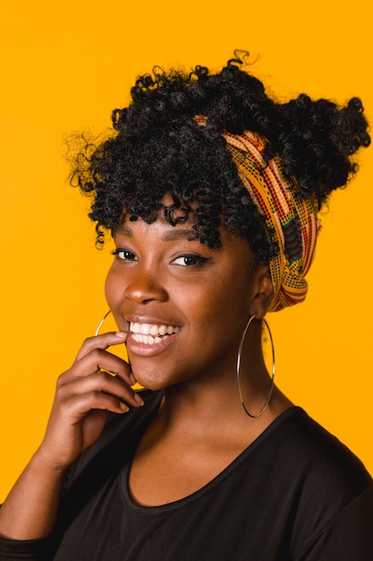 Positive African American curly young female on colored background