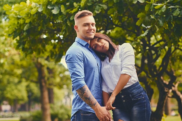 Positive attractive couple on a date in a city park.