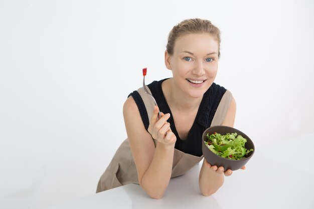 Positive beautiful woman watching her figure